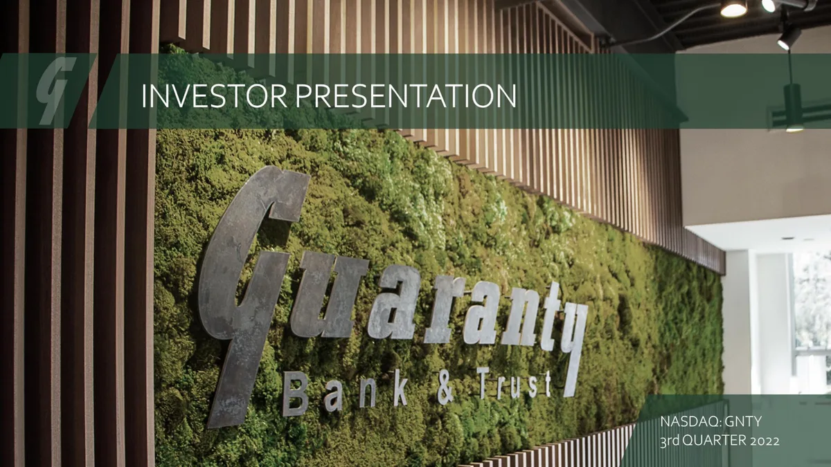 The slide features a branded moss wall with the company logo.