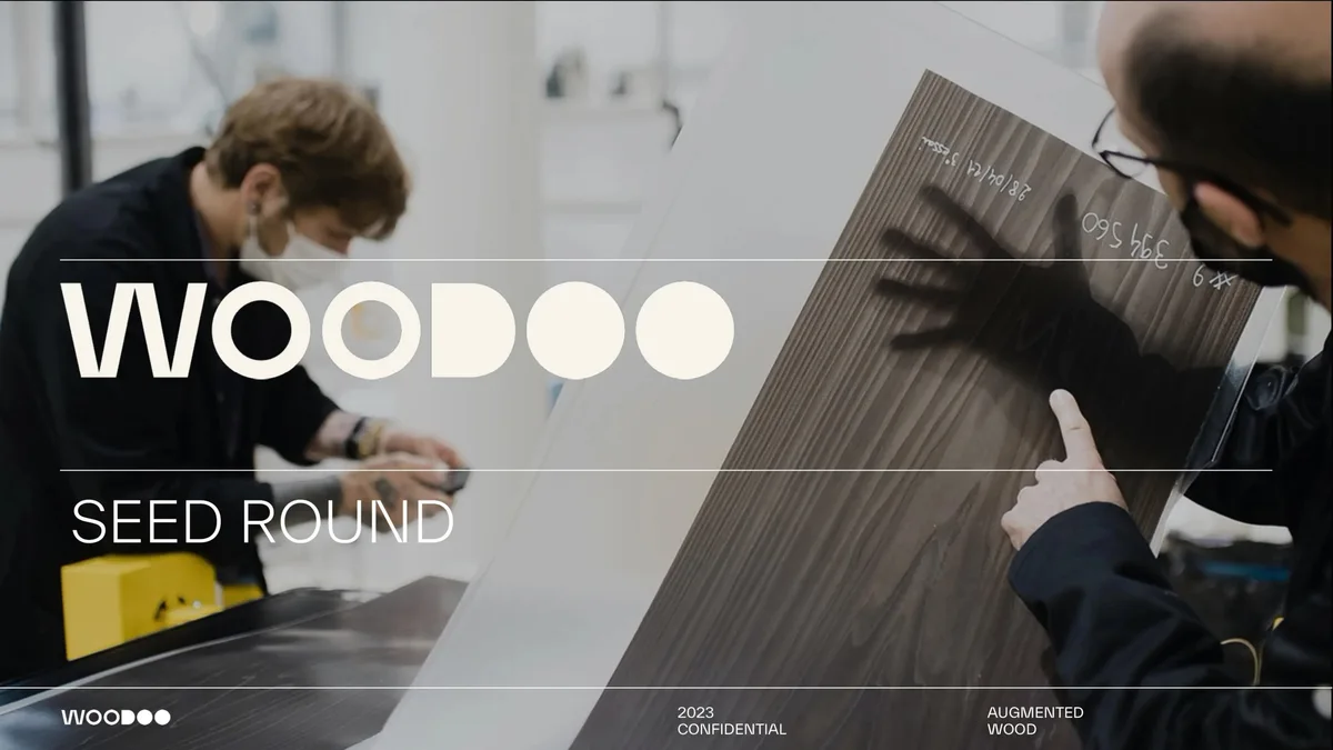 The slide features a photograph of a lab or manufacturing setting with a person holding a wood sample.
