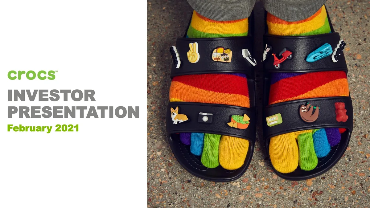 Features a lifestyle image of Crocs sandals with Jibbitz charms and rainbow toe socks.